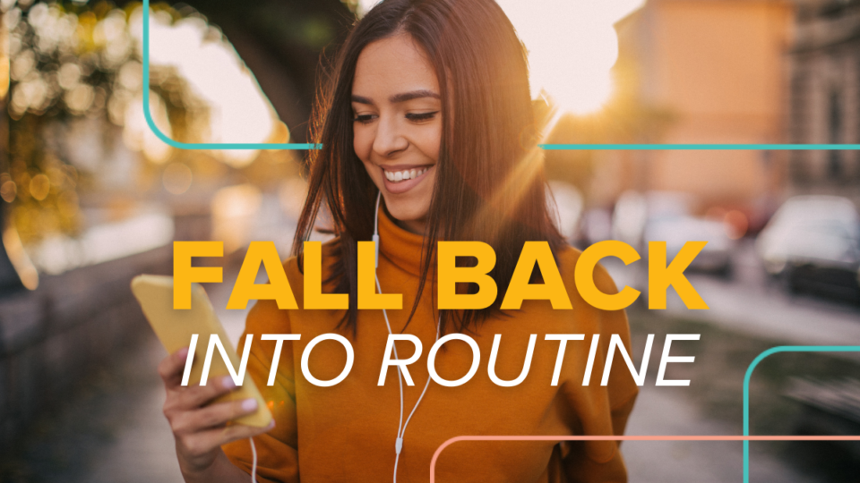 young woman, brunette, smiling at phone, researching how to get into fall productive routine