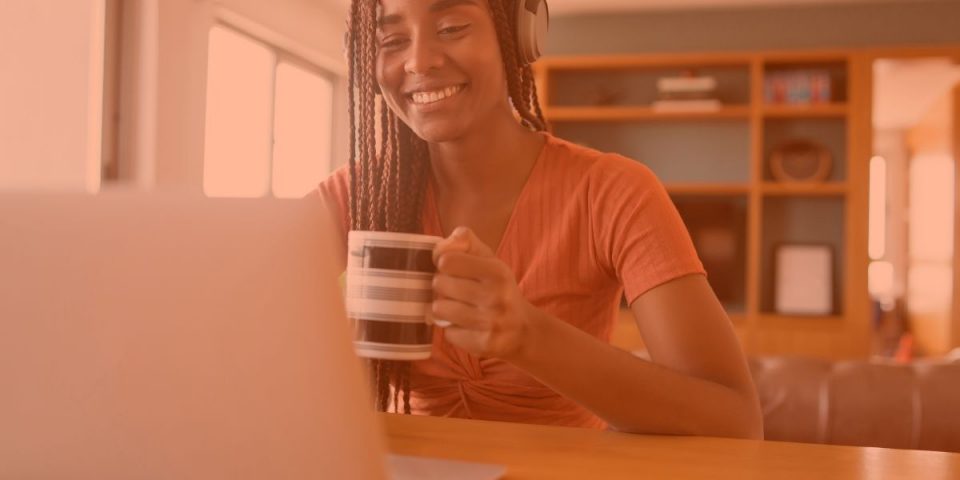 Virtual Gurus blog about 3 free resources for running your own VA business, showing a young VA at her home with a mug sitting in front of her laptop.