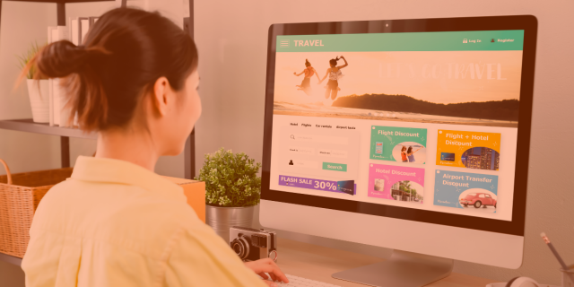 A web-savvy virtual assistant with Virtual Gurus updating a travel website on a large monitor in her home office.