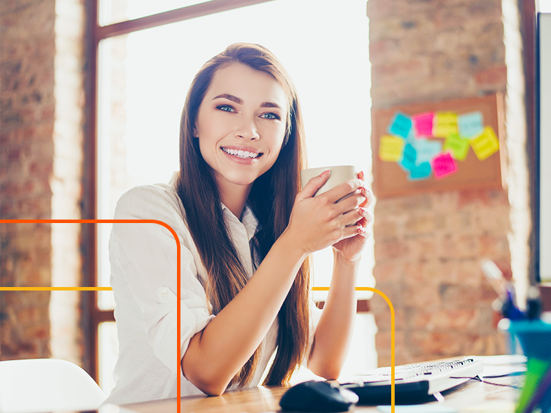 us-based virtual assistant, woman smiling and sipping coffee from her home office