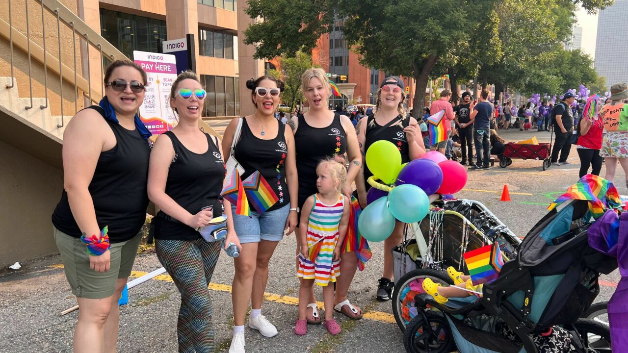 The Virtual Gurus team and their families celebrating the Pride Parade in Calgary.